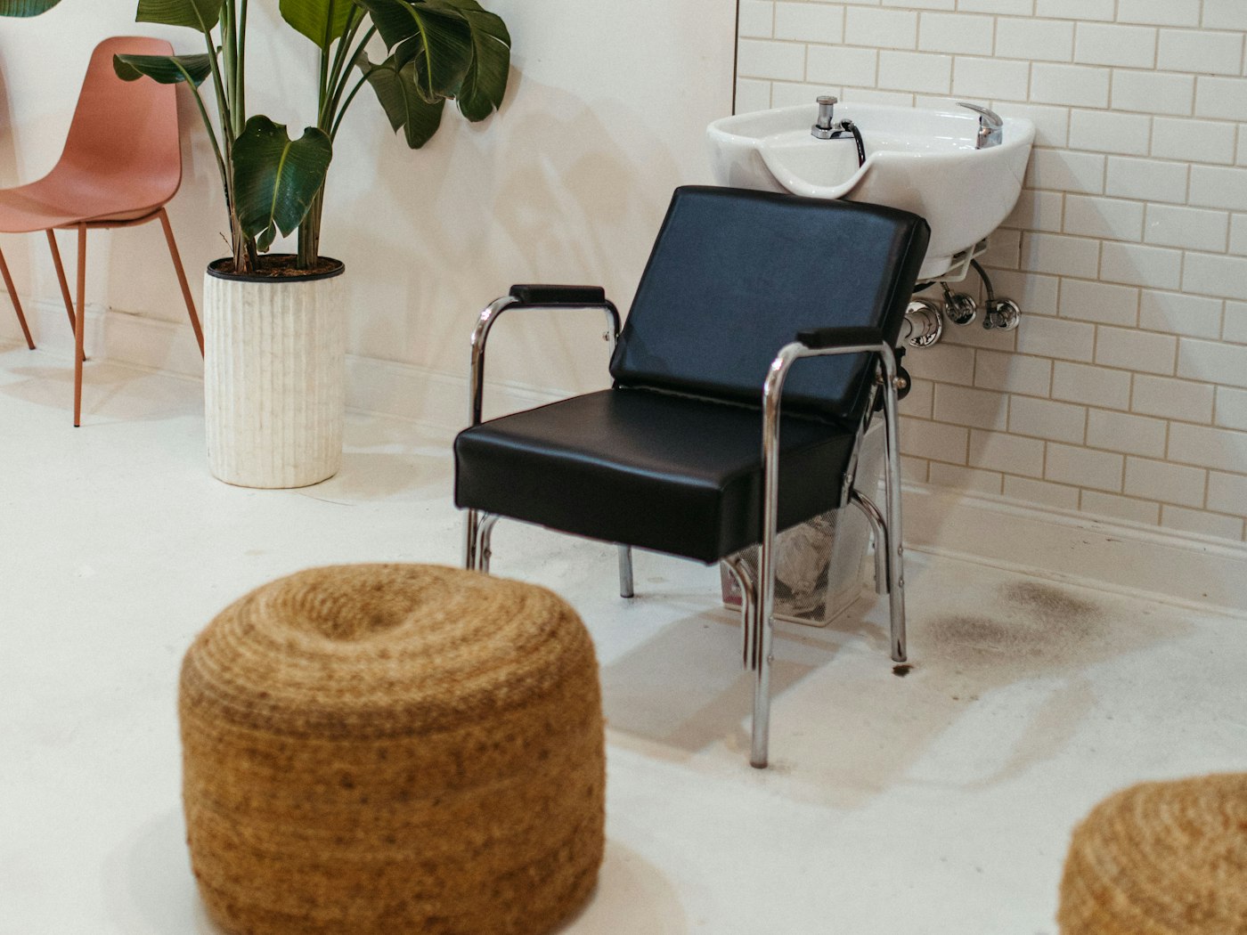 A styling chair and basin waiting by the window